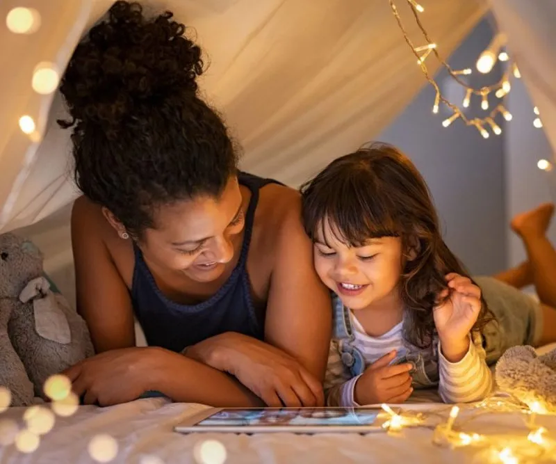smiling mother and daughter showing healthy teeth